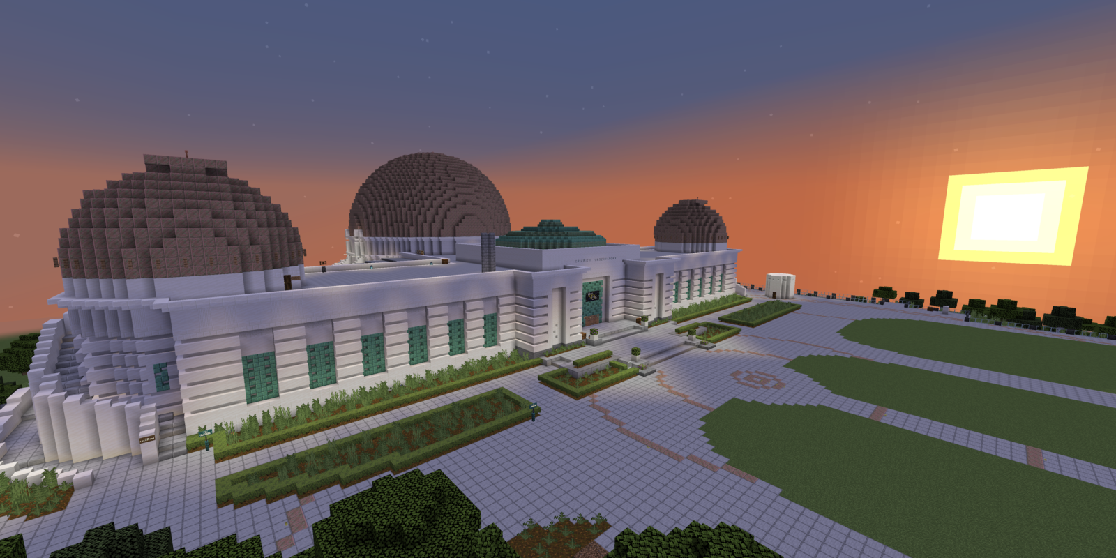 A Minecraft-style exterior view of Griffith Observatory and the sun setting.