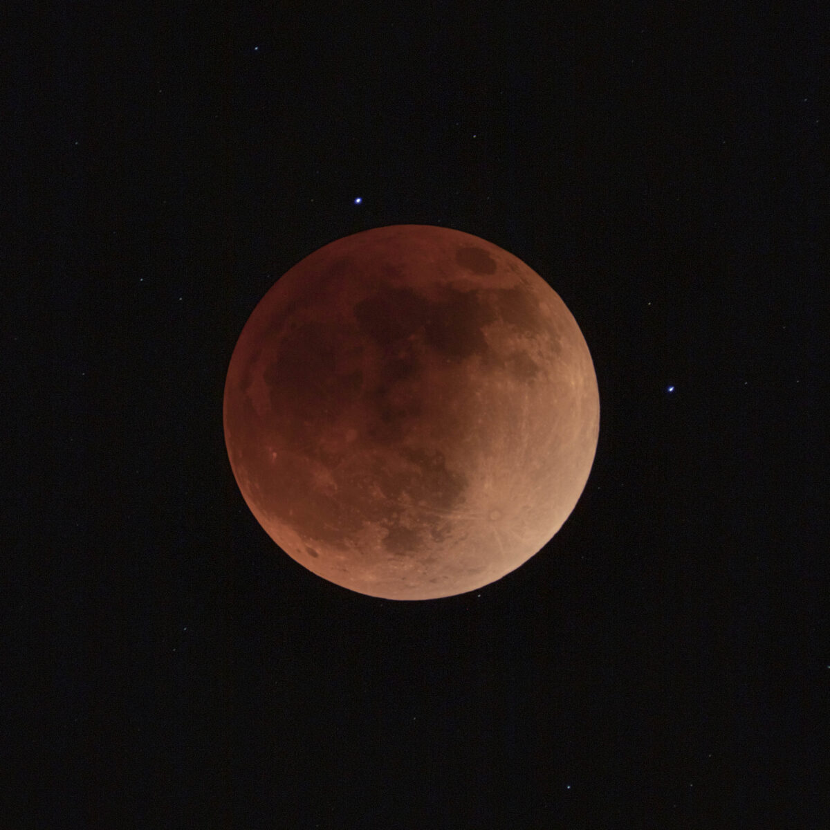 Closeup of a coppery-red full moon.